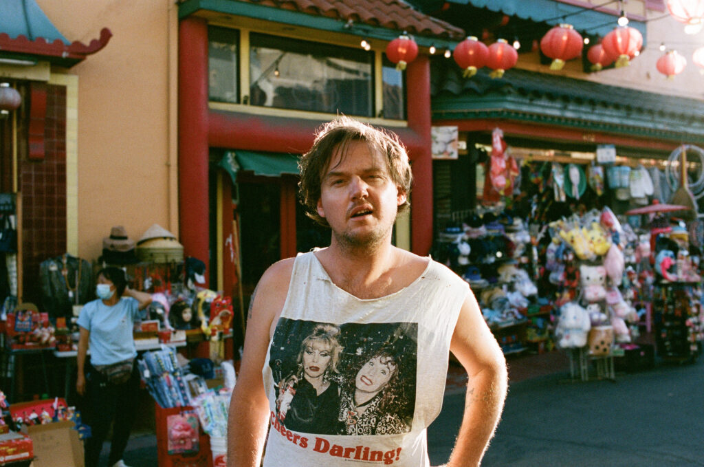 Peter Bibby press shot in a white singlet on the street